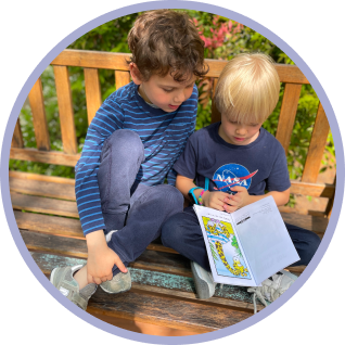 two students in elementary school reading a book
