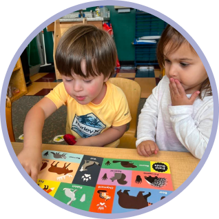 two preschool students doing a puzzle
