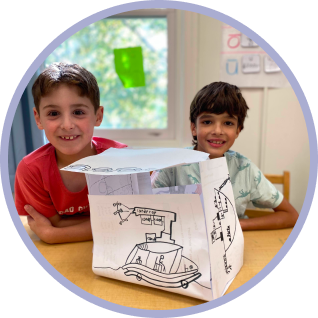 two students in elementary school with an art project