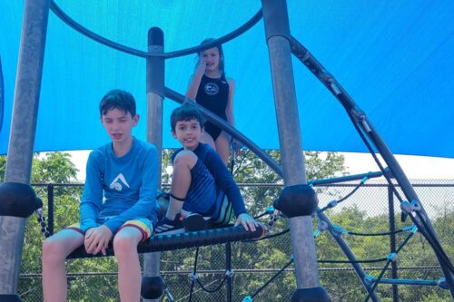 Kids on a playground at summer camp
