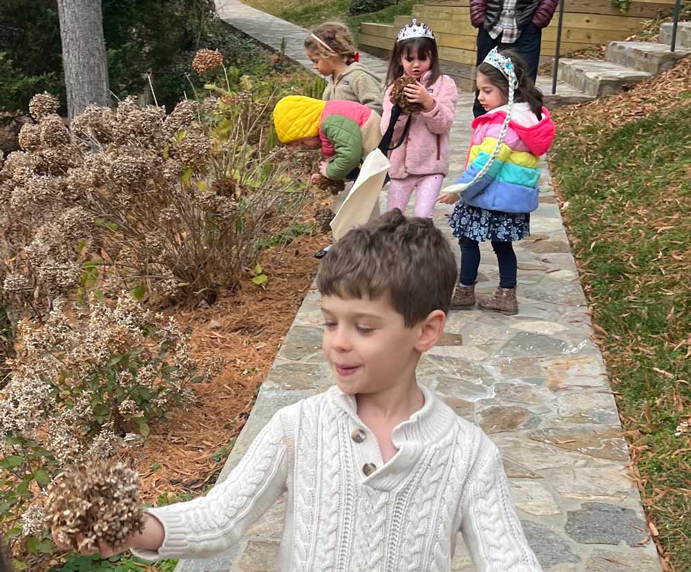 Kids walking outside and exploring with teacher
