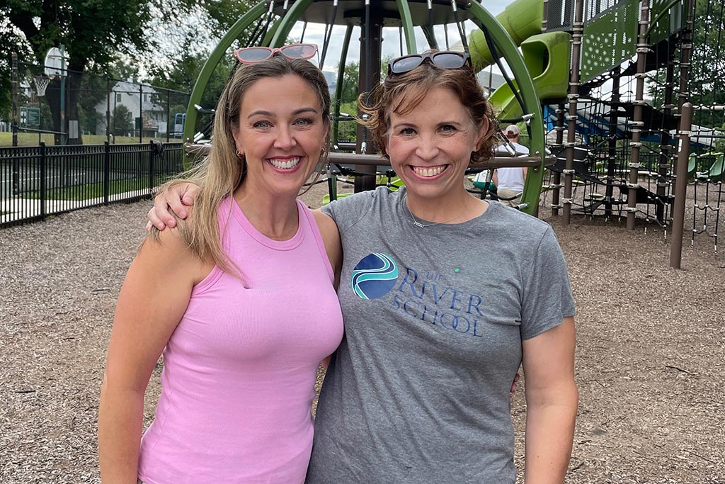 Parents at the River School in front of playground