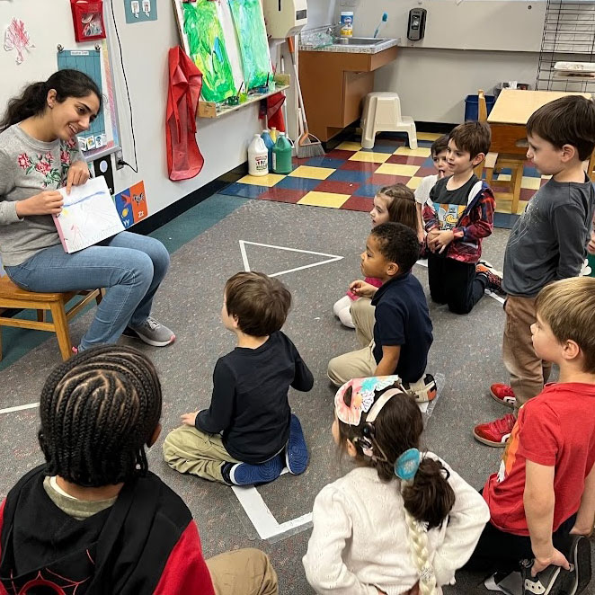 graduate student working with children at school
