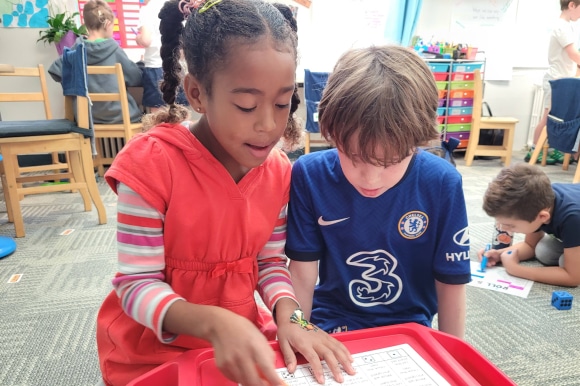 two students reading a book